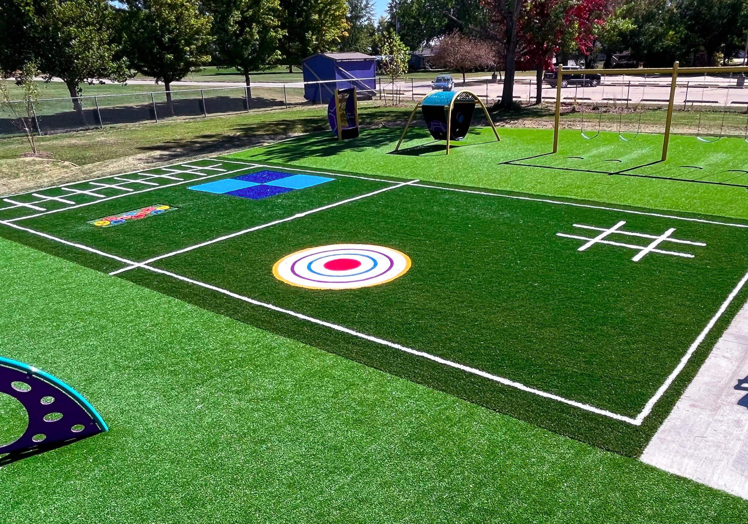 Playground with ForeverLawn synthetic grass featuring a 'Funserts'  design.